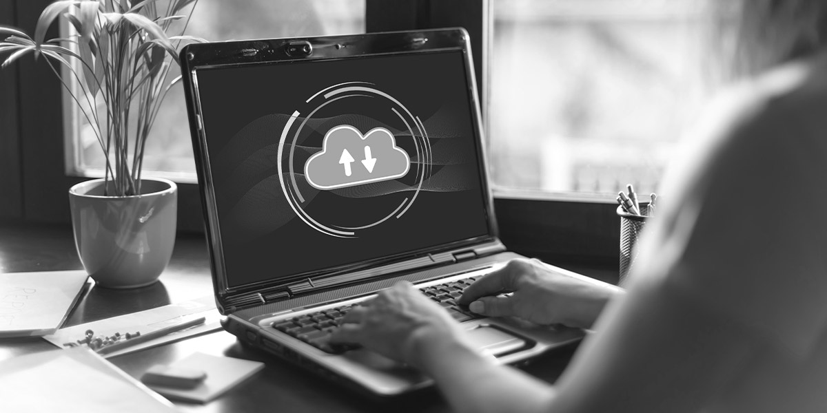 An employee using cloud storage sync on their business laptop.