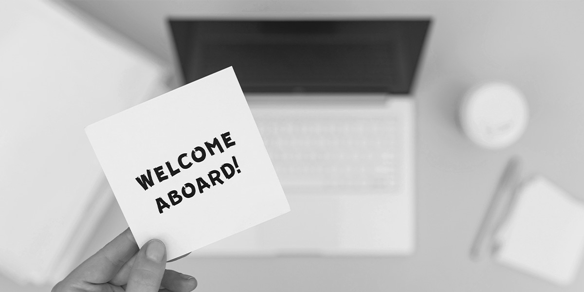 New employee onboarding procedure shown on a company laptop.